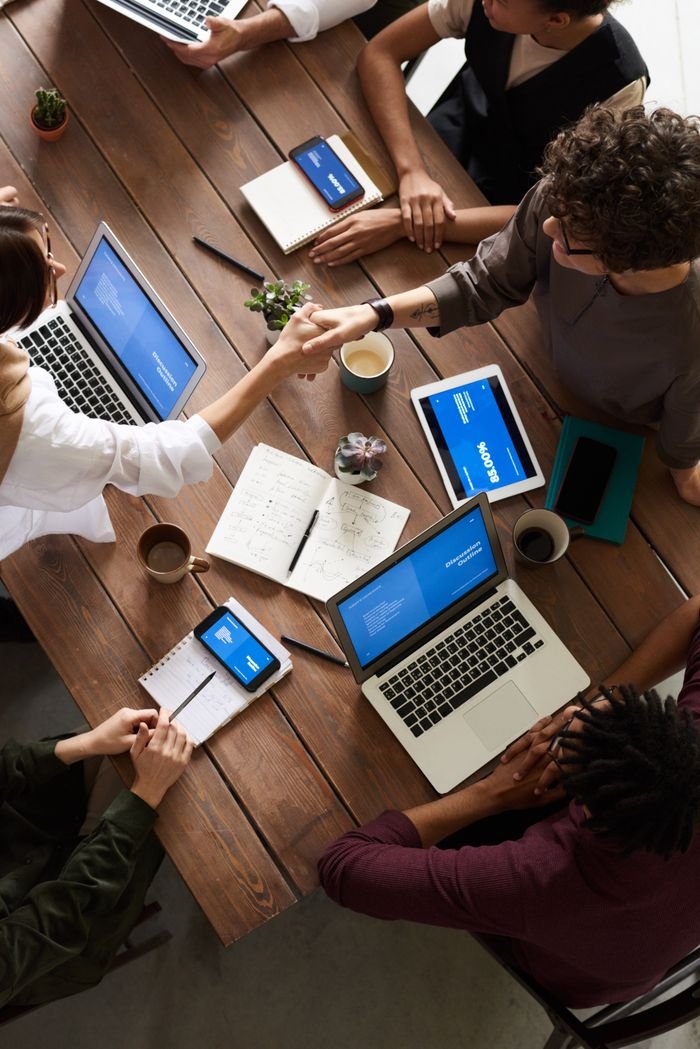 Crafting Captivating Headlines: Your awesome post title goes here A diverse group of professionals brainstorming in a modern workspace with laptops and notebooks.